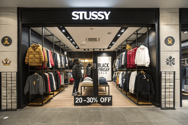 Stussy branded clothing on display with Black Friday sale signs