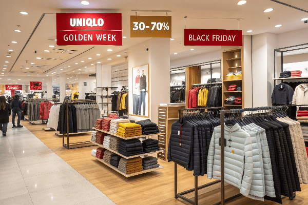 Uniqlo storefront with sale signs and customers shopping
