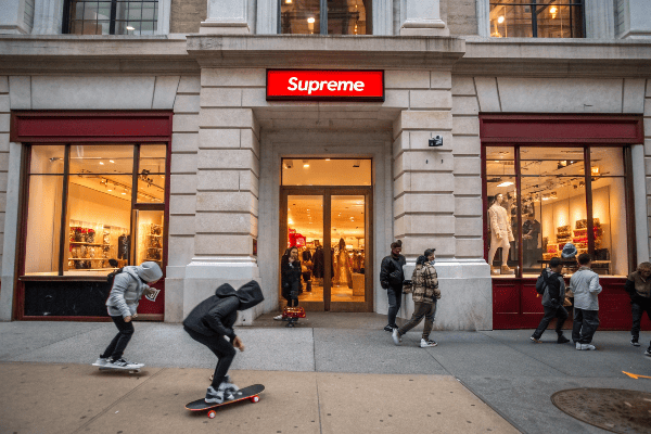 Supreme store location with skateboarders and brand imagery