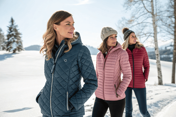 Women wearing stylish quilted jackets in winter setting